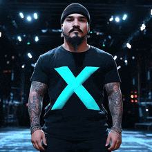 a man wearing a black shirt with a blue x on the front