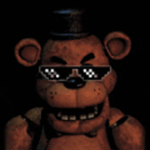 a brown teddy bear wearing sunglasses and a top hat in the dark .