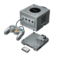 a silver nintendo gamecube with a controller and a memory card attached to it .