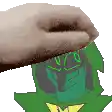a hand is holding a green object with a yellow star on it