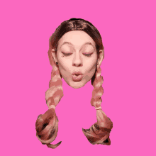 a woman with pigtails is blowing a kiss