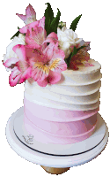 a pink and white cake with pink and white flowers on top of it