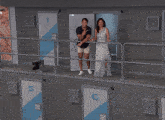 a man and a woman standing next to each other in front of a door that says ' lg ' on it