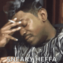 a man is covering his face with his hand while smoking a cigarette and says sneaky heffa