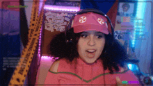 a girl wearing headphones and a pink hat with a candy cane on it