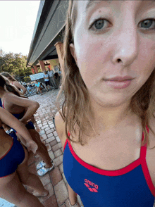 a woman in a blue and red arena swim suit