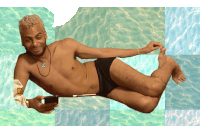 a shirtless man is laying in a pool holding a cellphone