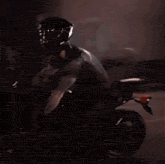 a man in a helmet is riding a motorcycle