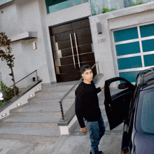 a man getting into a car in front of a house with the number 2351 on the door