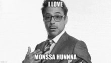 a black and white photo of a man in a suit and tie with the caption " i love monssa hunna "