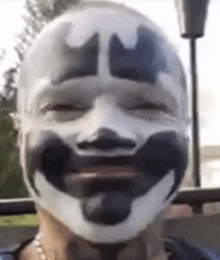 a close up of a person wearing a clown mask with a smile on their face .