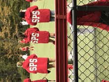 a group of people wearing red jackets that say sps on the back