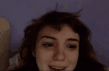 a close up of a girl 's face with a purple background