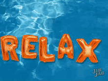 the word relax is written in orange balloons in the water