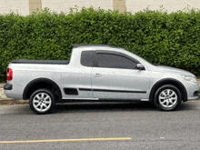 a silver pickup truck is parked on the street