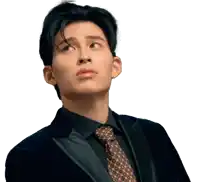 a man in a suit and tie is looking up at something