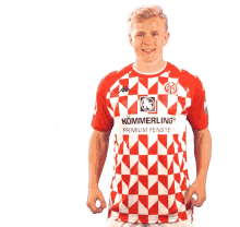 a man wearing a red and white shirt with kommerling premium fenster on it