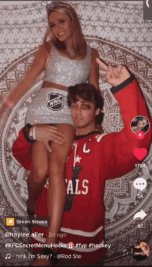 a woman in a nhl costume is being held by a man in a red als jersey