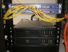 a server rack with two servers and a bunch of wires coming out of it .