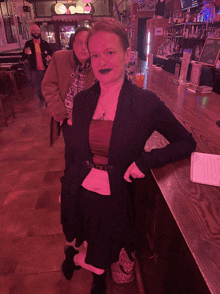 a woman leaning on a bar with a menu on the counter