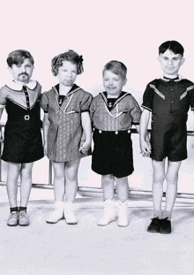 a group of children are posing for a picture and one of them has a fake mustache