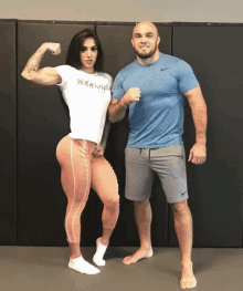 a man and a woman pose for a picture and the woman is wearing a shirt that says warrior