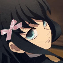 a girl with black hair has a pink bow on her head