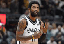 a man wearing a brooklyn jersey talks to someone