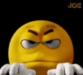 a cartoon smiley face with a very angry look on his face and white hands .