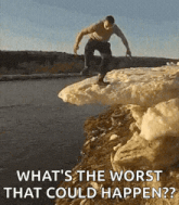 a man is jumping off a cliff into a lake .