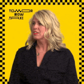 a woman stands in front of a yellow and black checkered background with the words to row taxi on it