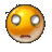 a yellow smiley face with a sad look on its face and a blurred background .