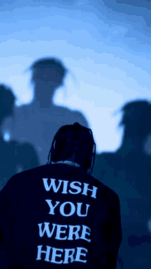 a man wearing a sweatshirt that says wish you were here