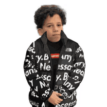 a young boy is wearing a jacket that says supreme