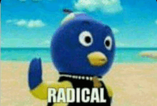 a blue penguin from backyardigans is standing on a beach with the words `` radical '' written on it .