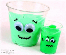 a cup of green slime with googly eyes and a cup of green slime with googly eyes .