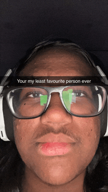 a man wearing glasses and headphones has a caption that says your my least favourite person ever