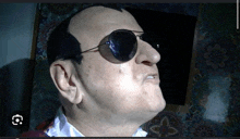 a close up of a man wearing sunglasses and a white shirt