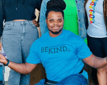 a man in a blue shirt that says bekind