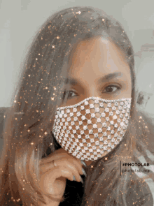 a woman wearing a rhinestone face mask with a photolab.me watermark