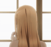 the back of a woman 's head is shown with a window in the background