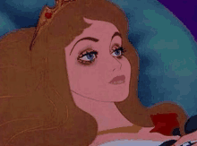 a close up of a sleeping princess wearing a tiara .