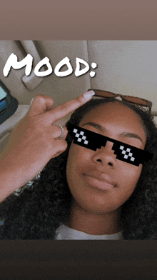 a woman wearing pixelated sunglasses with the word mood written above her