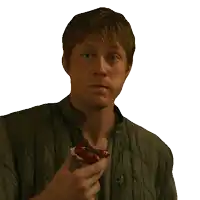 a man in a green jacket is holding a piece of food and asking me