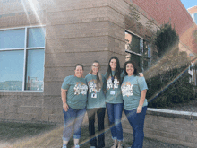 four women wearing shirts that say second grade are posing for a picture