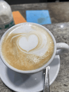 a cup of cappuccino with a heart shaped foam