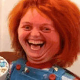 a close up of a person 's face with red hair