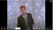 rick astley is dancing in front of a microphone in a youtube video