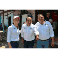 two men and a woman are posing for a picture and one of the men is wearing a shirt that says " jose antonio " on it