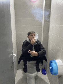 a man smoking a cigarette while squatting down on a toilet